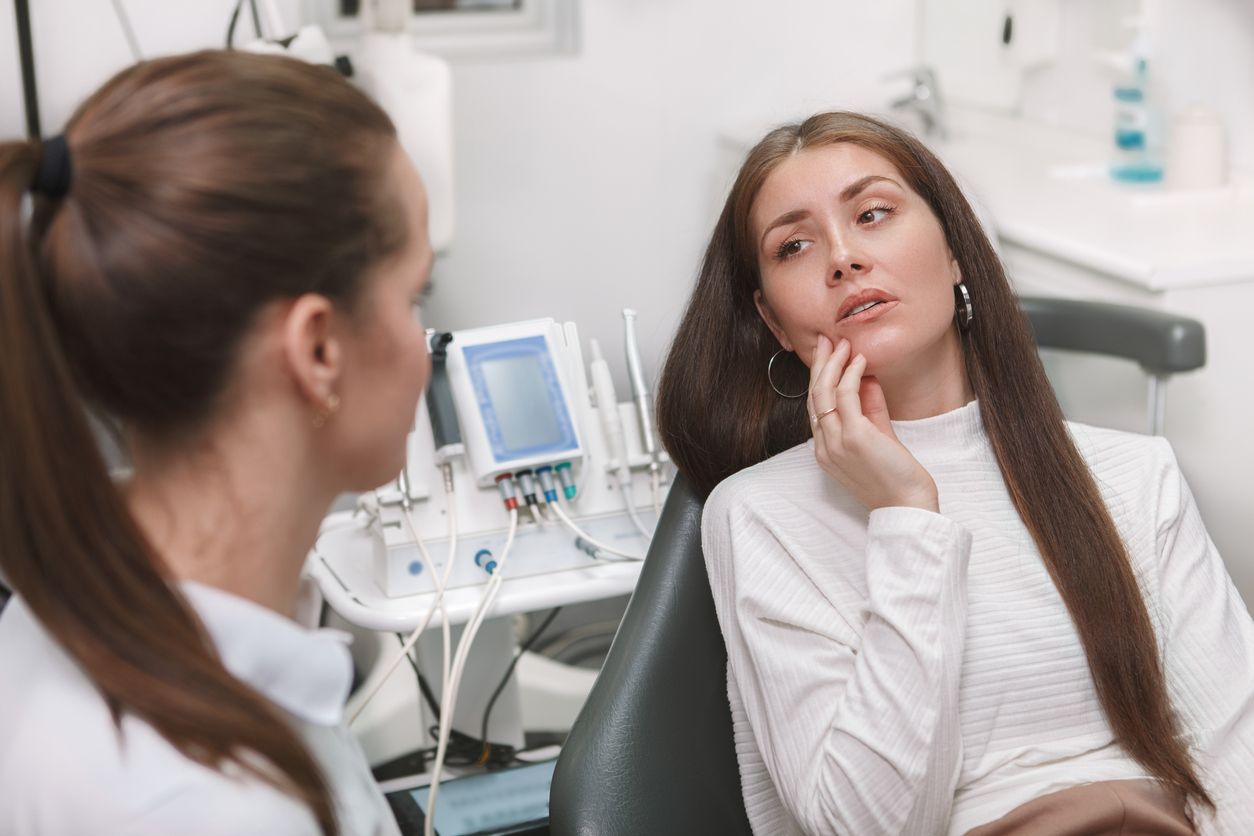 Woman discussing tooth discomfort with a dental professional