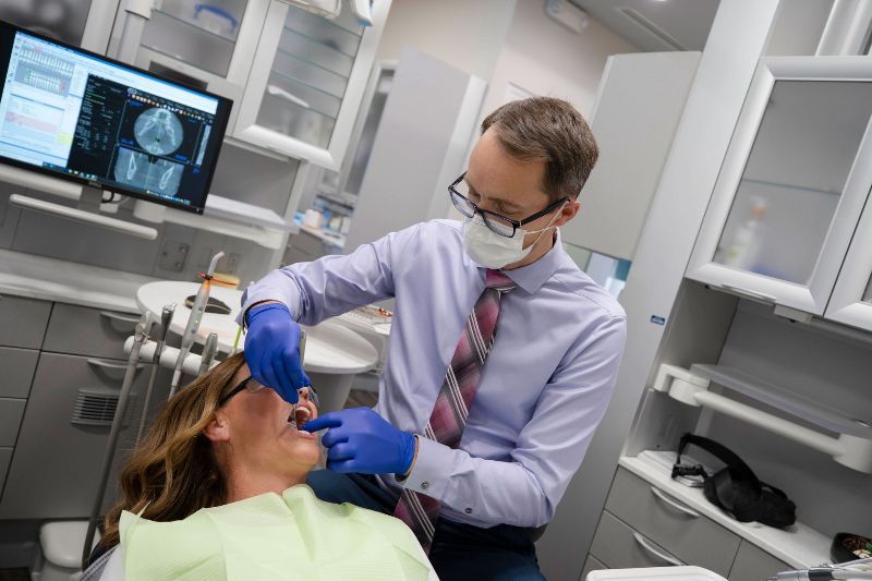 Dr. Matheson examining a patient at Bellissimo Dentistry